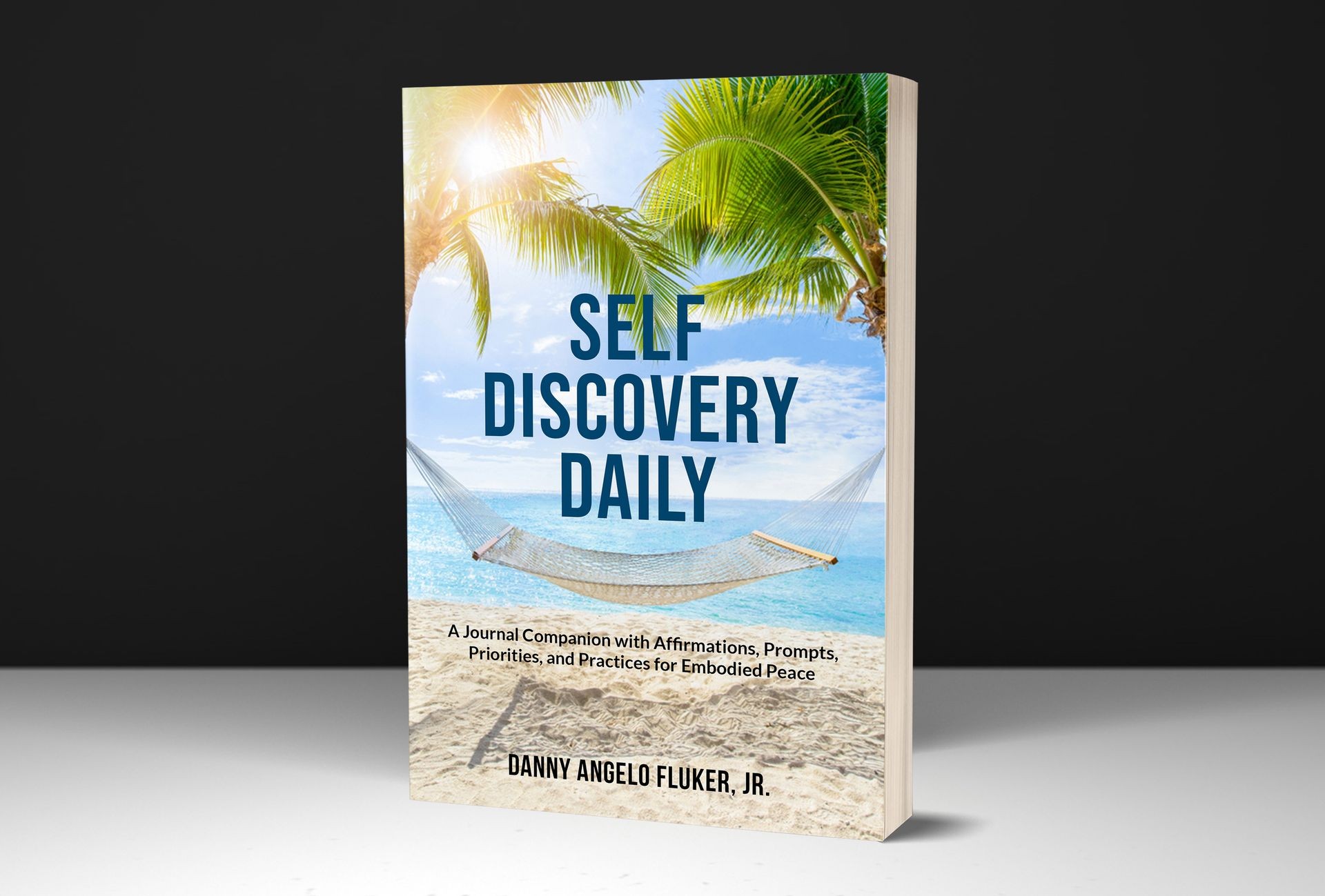 Book titled 'Self Discovery Daily' with beach and hammock background.